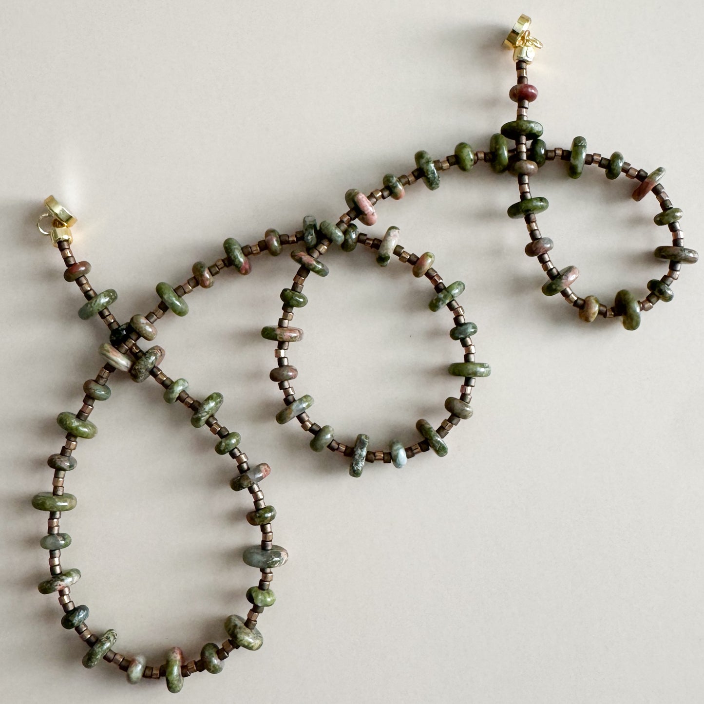 Beaded necklace and bracelet set on a light background