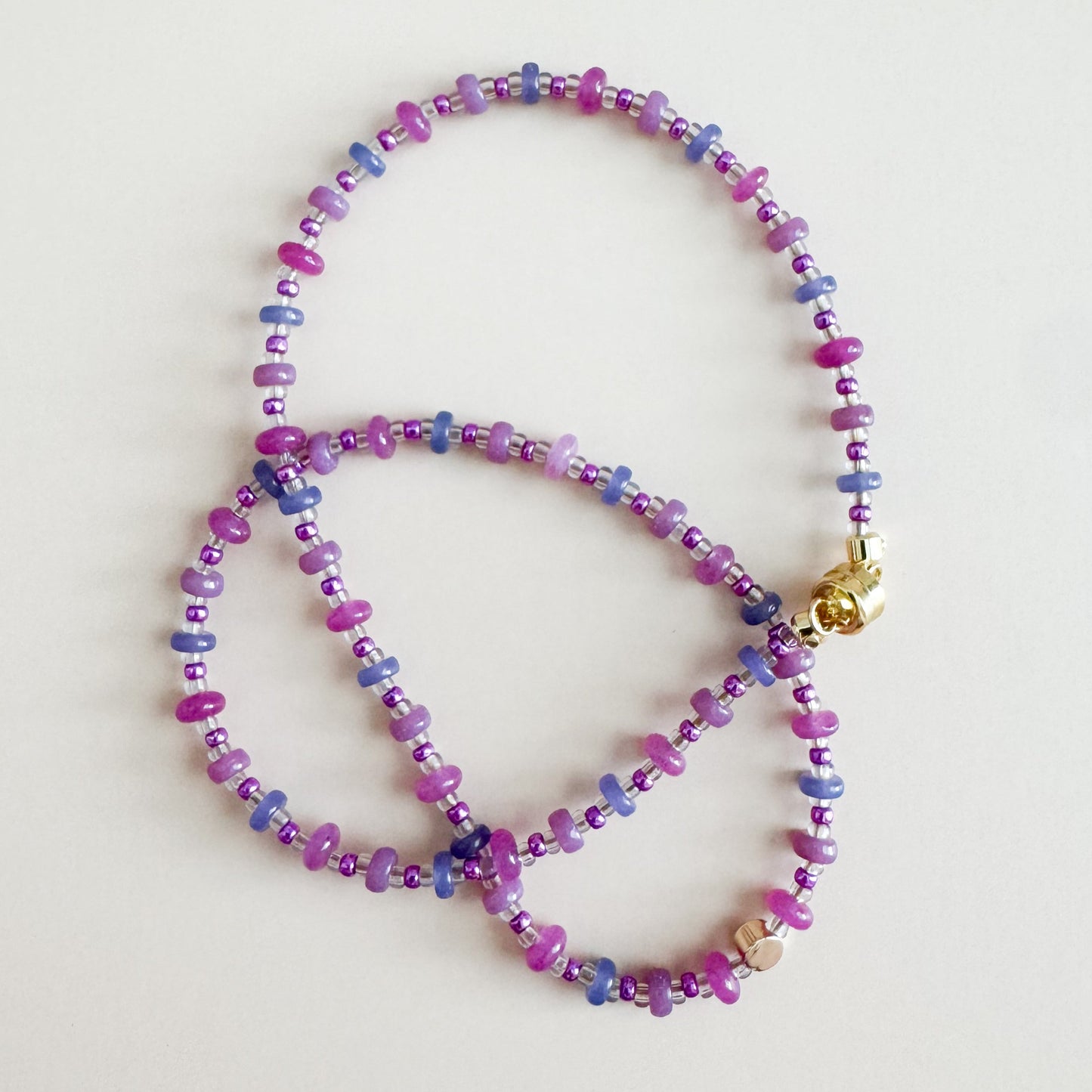 Multicolored beaded necklace on a light gray background