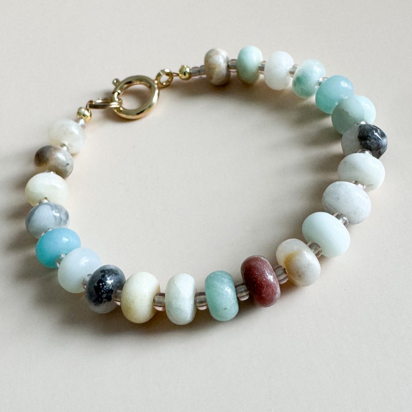Beaded bracelet with multicolored beads on a light background
