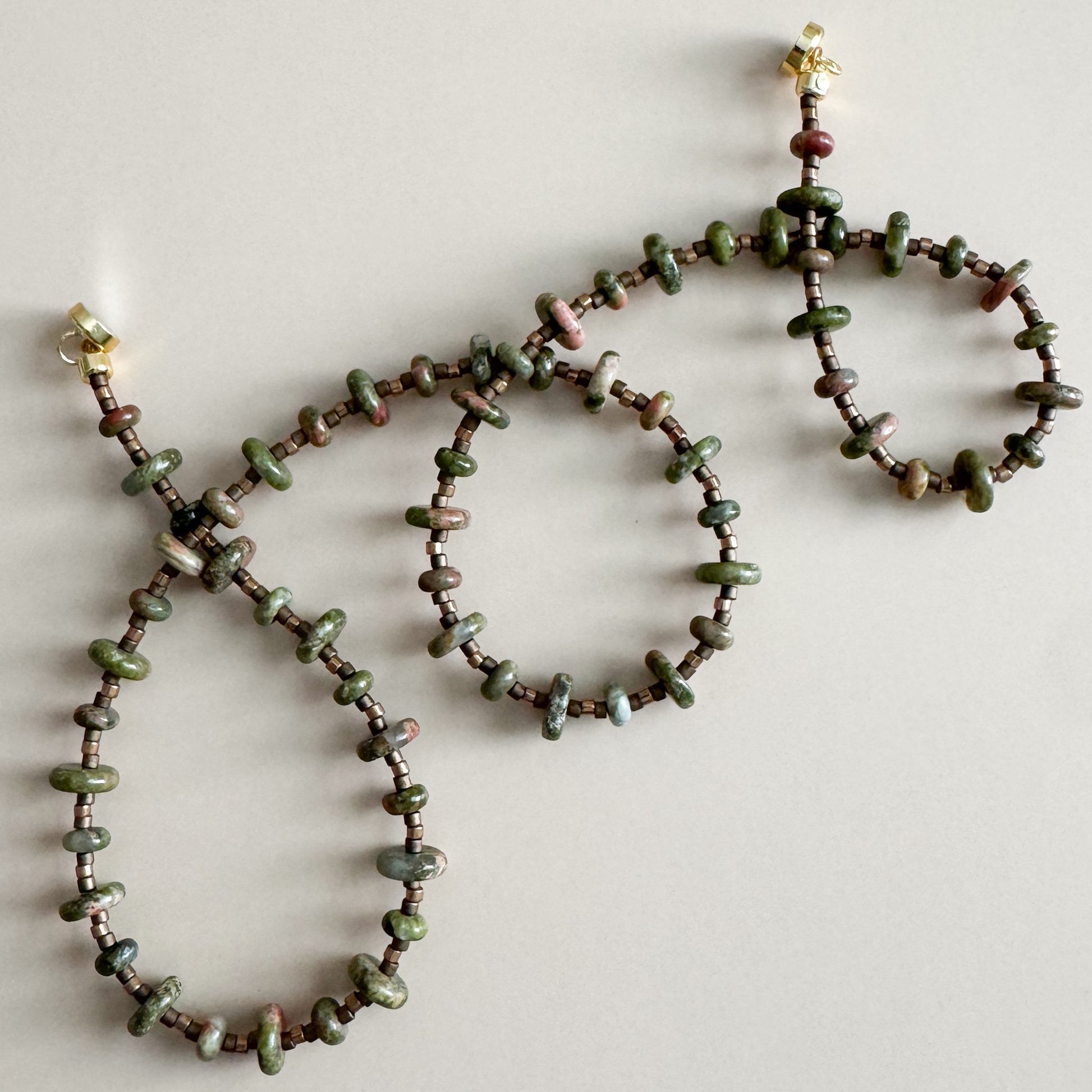 Beaded necklace and bracelet set on a light background