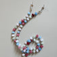 Beaded lanyard with colorful beads on a plain background