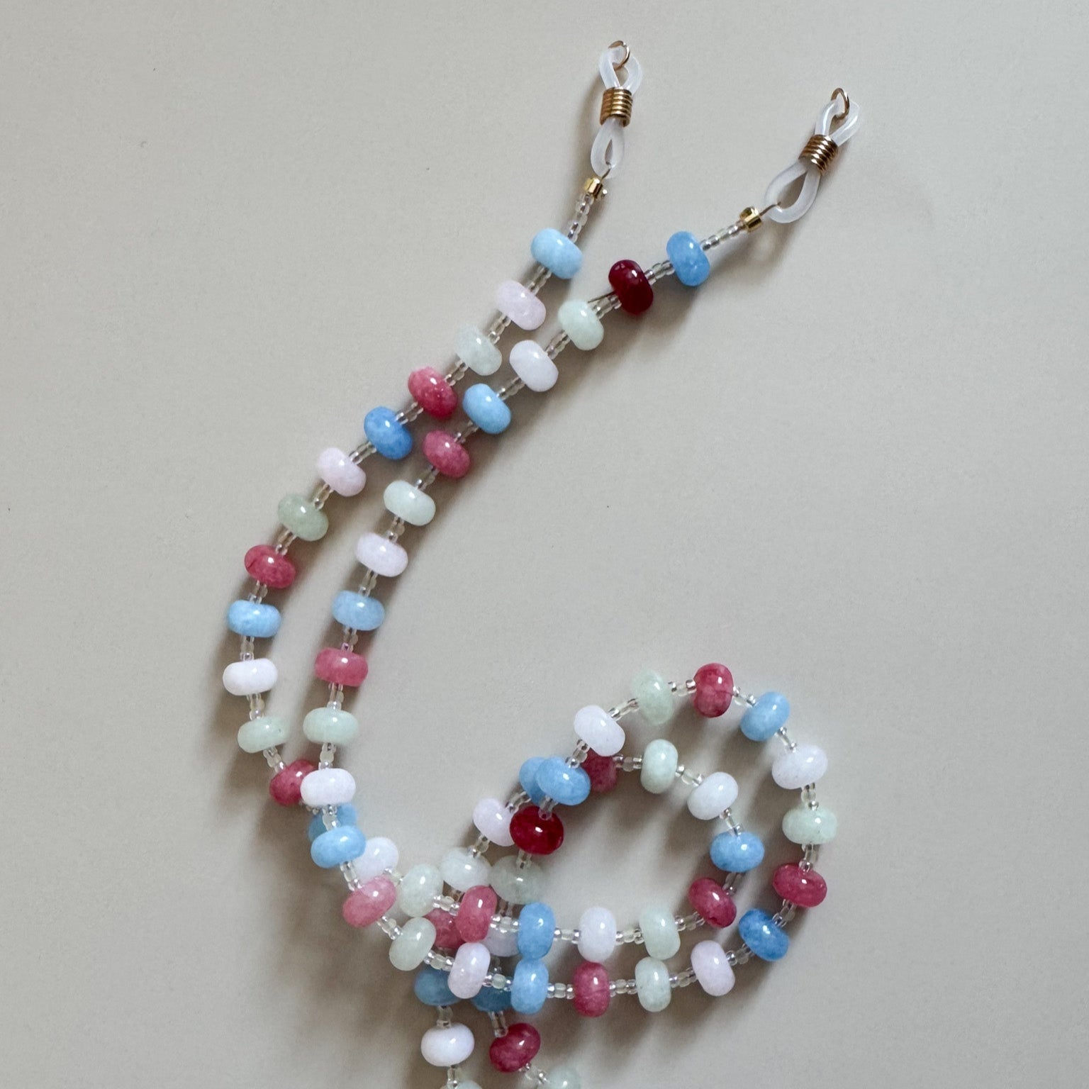 Beaded lanyard with colorful beads on a plain background