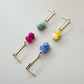 Colorful beaded earrings on a light gray background
