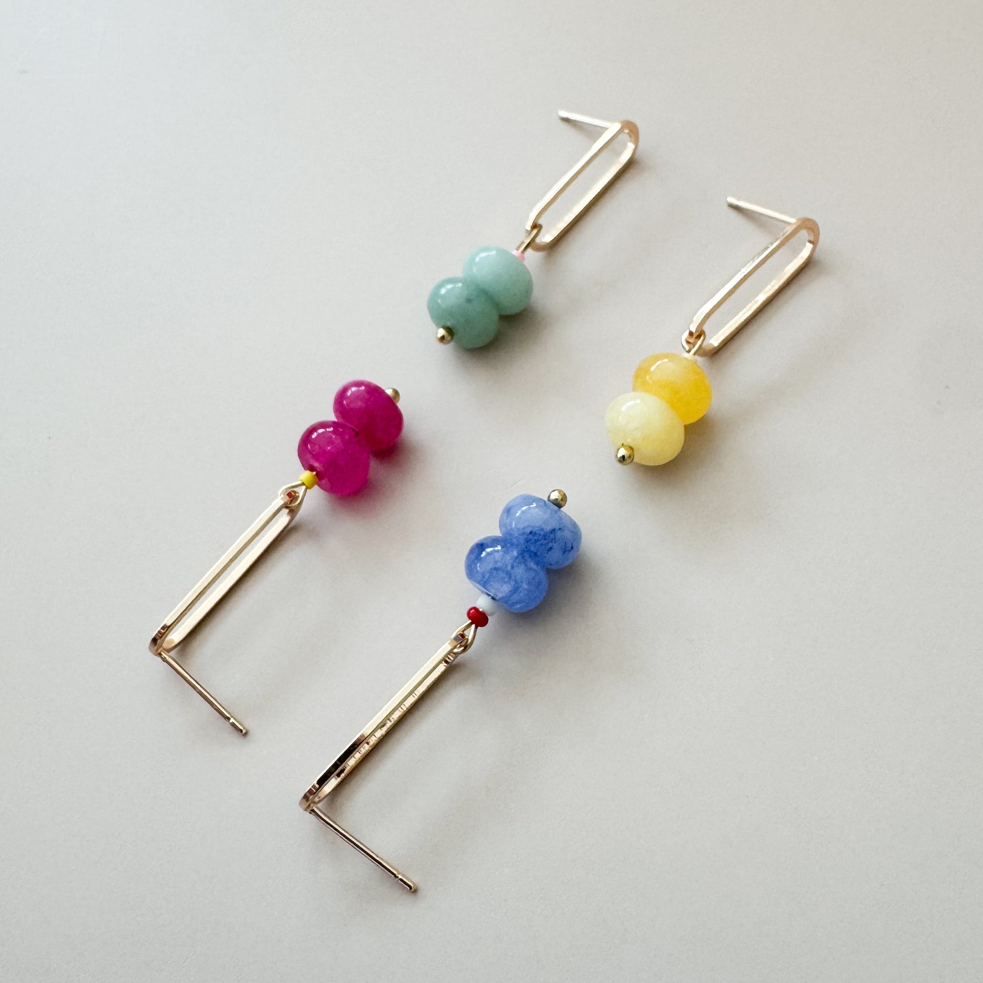 Colorful beaded earrings on a light gray background