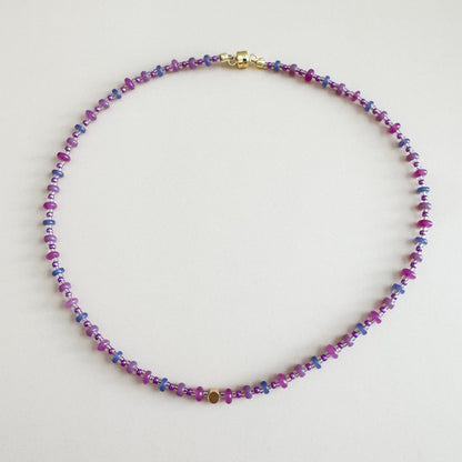 Multicolored beaded necklace on a light gray background